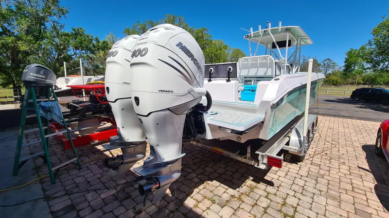 Slide: The Image of 2025 Custom Core 38 Center Console boat with twin outboard engines on a trailer. - 28