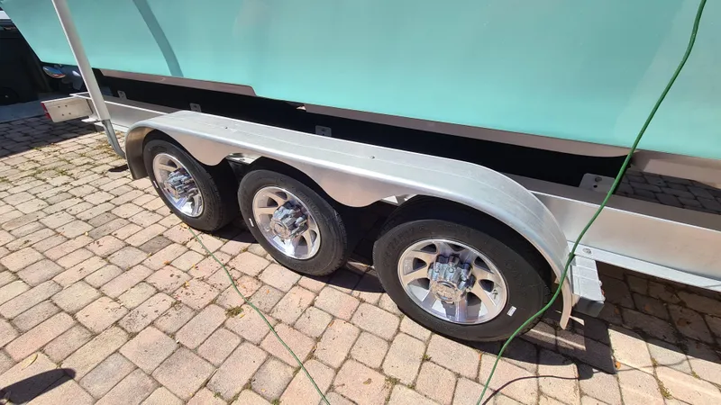 Slide: The Image of Triple-axle trailer for 2025 Custom Core 38 Center Console boat on brick pavement. - 32
