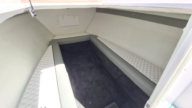 Slide: The Image of Interior cabin of 2025 Custom Core 38 Center Console boat, featuring cushioned seating. - 5