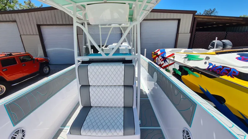 Slide: The Image of 2025 Custom Core 38 Center Console boat with sleek seating and vibrant design. - 7
