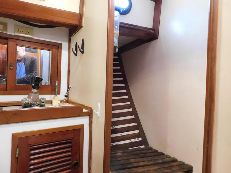 Slide: The Image of Interior of 1984 Tayana 37 sailboat with wooden stairs and cabinetry. - 12