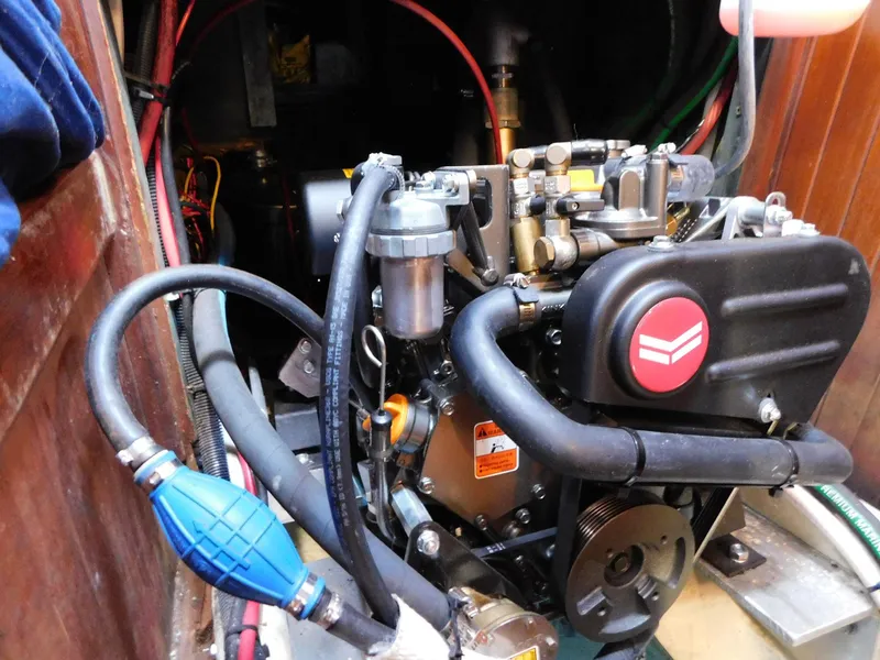 Slide: The Image of Engine compartment of a 1984 Tayana 37 sailboat, showcasing detailed mechanical components. - 13