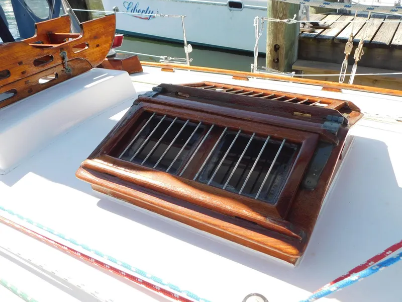 Slide: The Image of Wooden hatch on 1984 Tayana 37 sailboat deck, featuring metal bars and nautical design. - 17