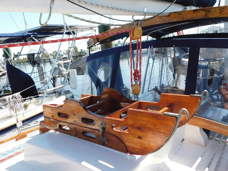 Slide: The Image of 1984 Tayana 37 sailboat cockpit with wooden details and nautical equipment. - 18