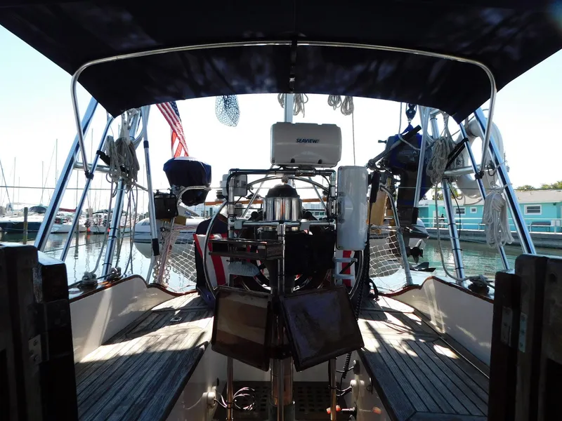 Slide: The Image of 1984 Tayana 37 sailboat cockpit with canopy, docked at marina. - 20