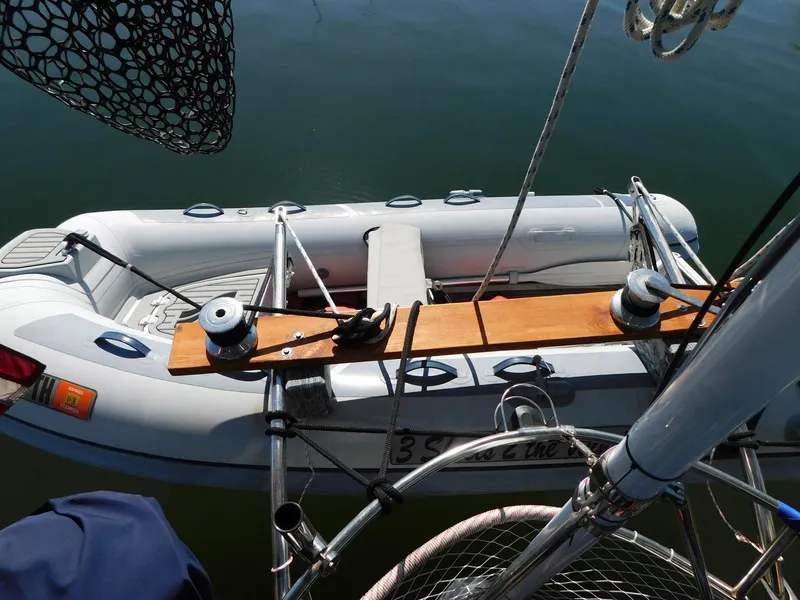 Slide: The Image of Inflatable dinghy secured on 1984 Tayana 37 sailboat, viewed from above. - 25