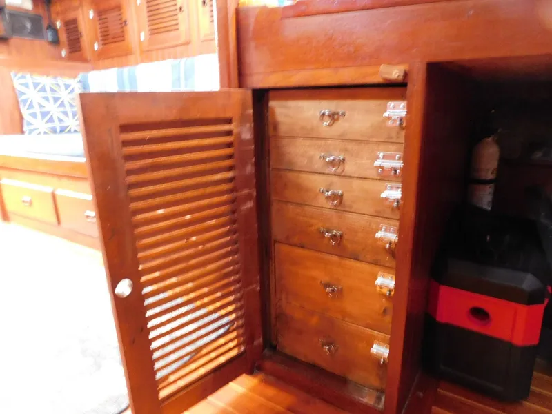 Slide: The Image of Wooden interior of 1984 Tayana 37 sailboat with open cabinet and drawers. - 5