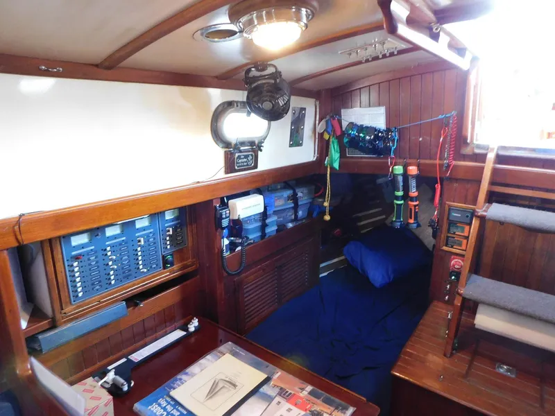 Slide: The Image of Cozy interior of 1984 Tayana 37 sailboat with wood paneling and navigation equipment. - 7