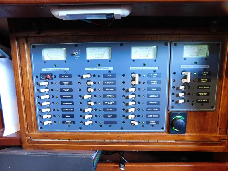 Slide: The Image of Electrical control panel on a 1984 Tayana 37 sailboat, featuring switches and gauges. - 8
