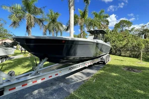 Slide: The Image of 1996 Formula 382 SR1 boat on trailer, surrounded by palm trees and greenery. - 12