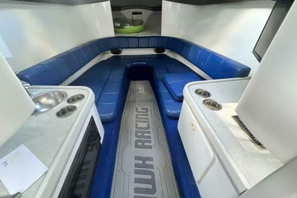 Slide: The Image of 1996 Formula 382 SR1 boat interior with blue seating and kitchenette. - 18