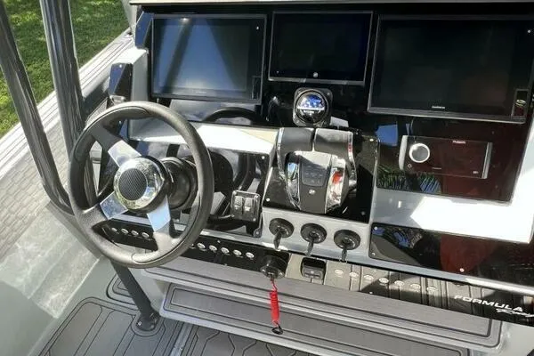 Slide: The Image of 1996 Formula 382 SR1 boat dashboard with steering wheel and control panels. - 22