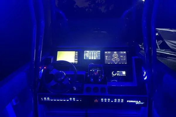 Slide: The Image of 1996 Formula 382 SR1 boat cockpit illuminated with blue LED lights at night. - 24
