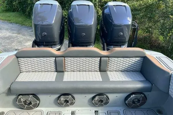 Slide: The Image of 1996 Formula 382 SR1 boat with triple outboard engines and cushioned seating. - 28