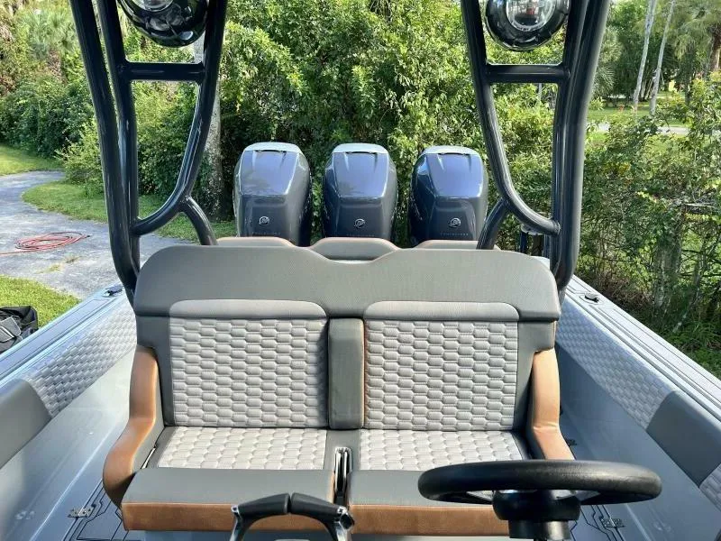 Slide: The Image of 1996 Formula 382 SR1 boat interior with triple outboard motors and cushioned seating. - 29