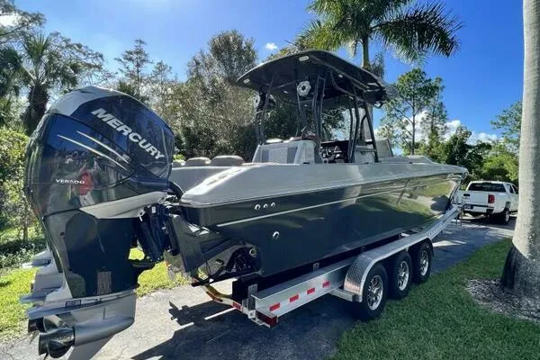 Slide: The Image of 1996 Formula 382 SR1 boat on trailer with Mercury engine, surrounded by trees. - 3