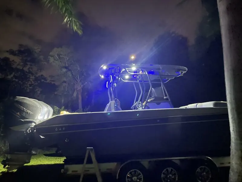 Slide: The Image of 1996 Formula 382 SR1 boat illuminated at night, parked on a trailer in a wooded area. - 38