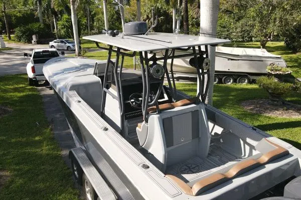 Slide: The Image of 1996 Formula 382 SR1 boat on trailer, parked outdoors with lush greenery. - 6