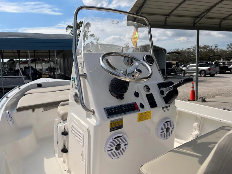 Slide: The Image of 2025 Key West 1720 Center Console boat interior with steering wheel and control panel. - 10