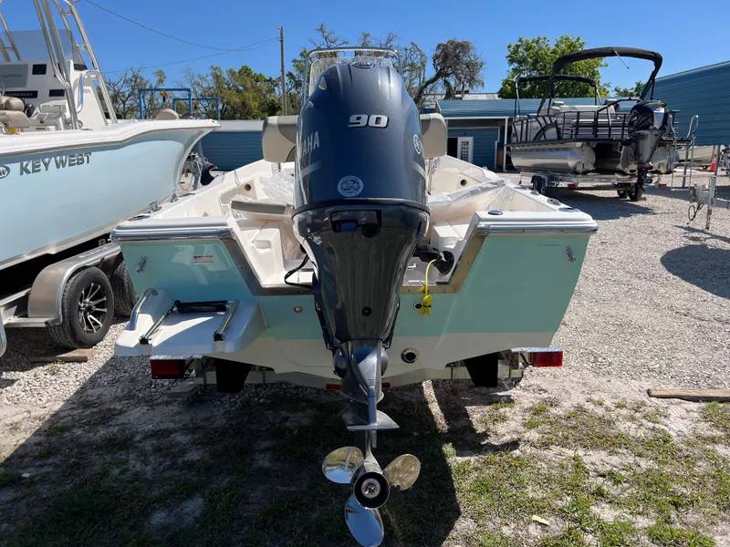 Slide: The Image of 2025 Key West 1720 Center Console boat with Yamaha 90 engine, parked outdoors. - 5