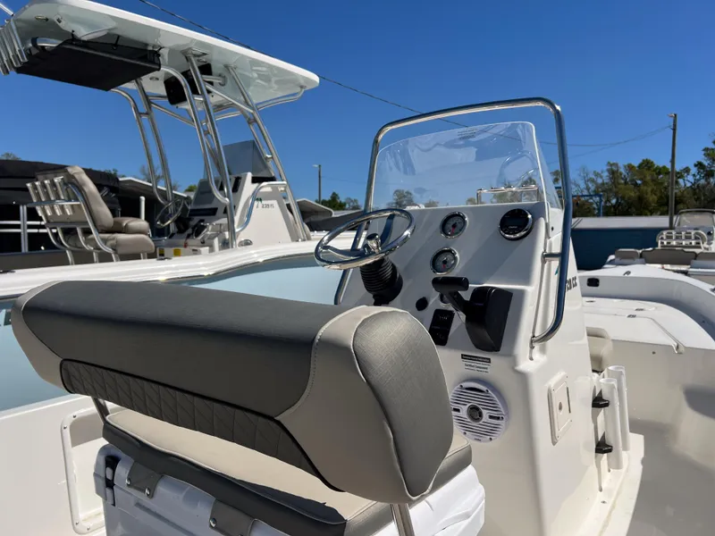 Slide: The Image of 2025 Key West 1720 Center Console boat interior with steering wheel and seating. - 6