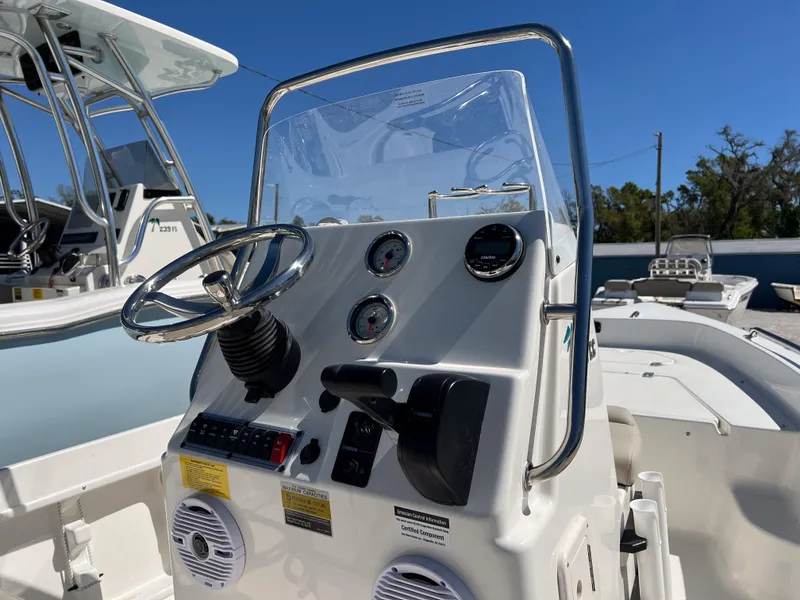 Slide: The Image of 2025 Key West 1720 Center Console boat dashboard with steering wheel and gauges. - 7