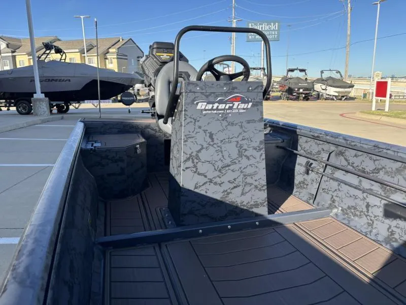 Slide: The Image of 2025 Gator Tail 18/60 Extreme Series boat with camouflage design in a parking lot. - 10
