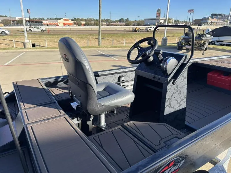 Slide: The Image of 2025 Gator Tail 18/60 Extreme Series boat interior with steering console and seat. - 12