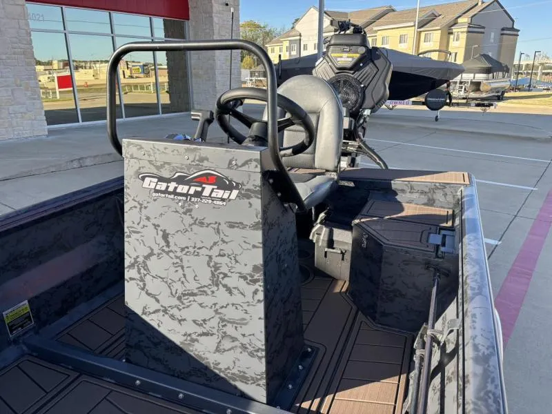 Slide: The Image of 2025 Gator Tail 18/60 Extreme Series boat interior with steering console and seat. - 13