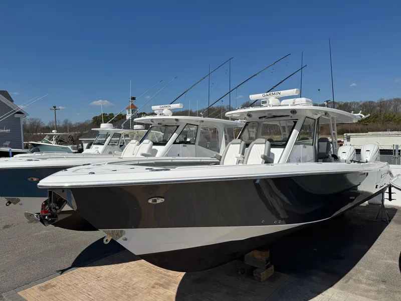 The Image of 2022 Everglades 395cc boats docked under clear blue sky. - 0