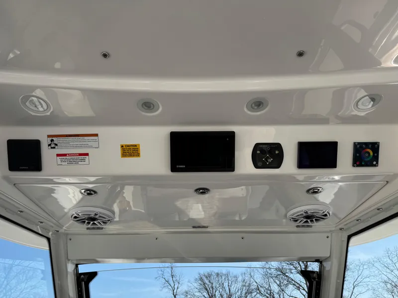 Slide: The Image of Control panel of 2022 Everglades 395cc boat with speakers and electronic displays. - 12