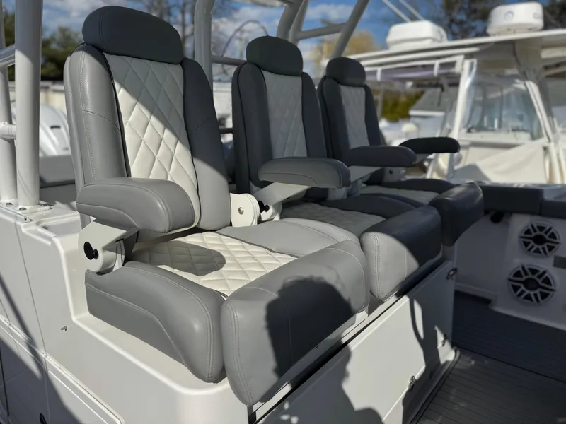 Slide: The Image of Luxury seating on 2022 Everglades 395cc boat, featuring gray and white upholstery. - 13