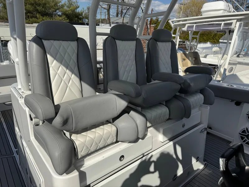 Slide: The Image of Luxury seating on 2022 Everglades 395cc boat with gray and white upholstery. - 15