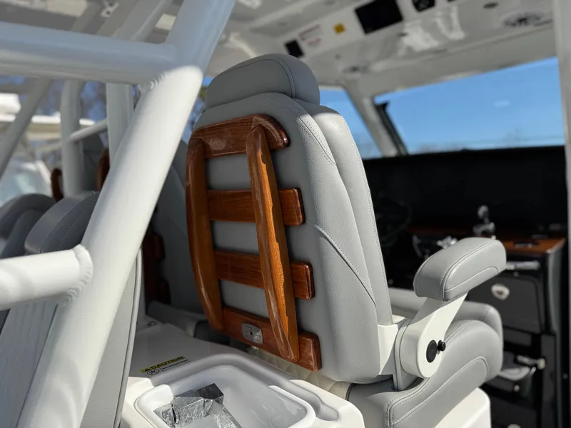 Slide: The Image of Luxury seating in 2022 Everglades 395cc boat, featuring sleek design and wooden accents. - 16
