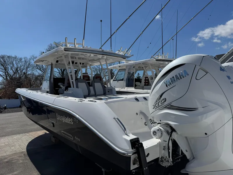 Slide: The Image of 2022 Everglades 395cc boat with Yamaha engine, docked under clear blue sky. - 2