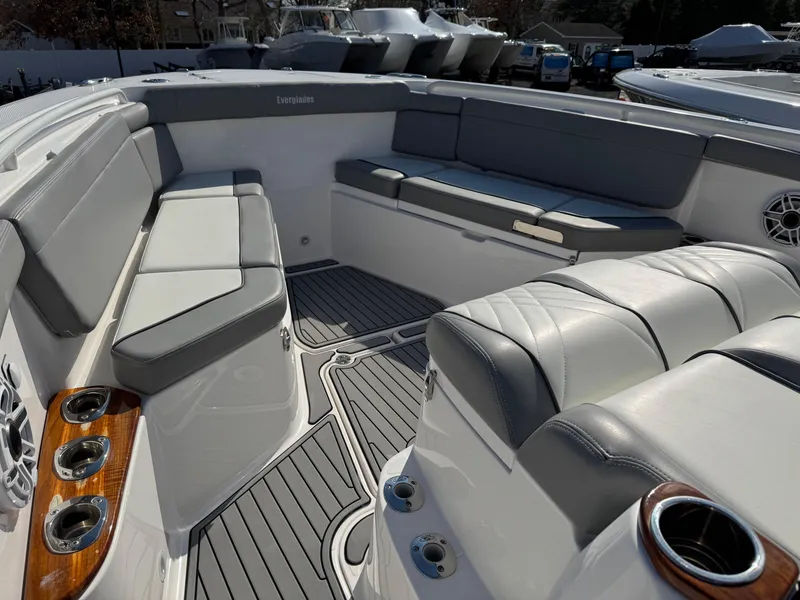 Slide: The Image of 2022 Everglades 395cc boat interior with gray seating and wood accents. - 4