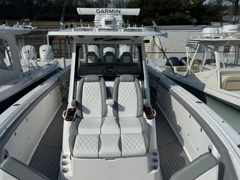 Slide: The Image of 2022 Everglades 395cc boat with Garmin equipment, featuring luxurious seating and sleek design. - 5