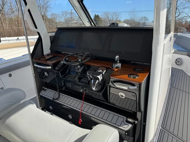 Slide: The Image of 2022 Everglades 395cc boat helm with modern controls and sleek design. - 8
