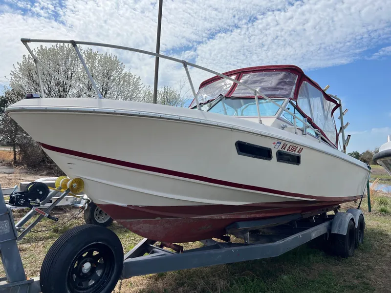 Slide: The Image of 1978 Wellcraft NOVA boat on trailer, white with red accents, under a partly cloudy sky. - 2