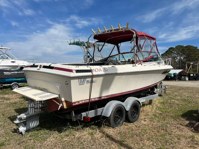 Slide: The Image of 1978 Wellcraft NOVA boat on trailer, red canopy, parked on grass under blue sky. - 4
