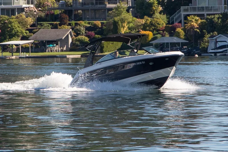 Slide: The Image of 2020 Sea Ray SLX 250 boat cruising on a scenic lake. - 17