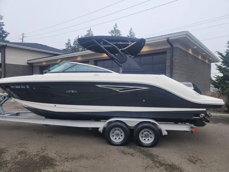 Slide: The Image of 2020 Sea Ray SLX 250 boat on trailer, parked in residential driveway. - 18