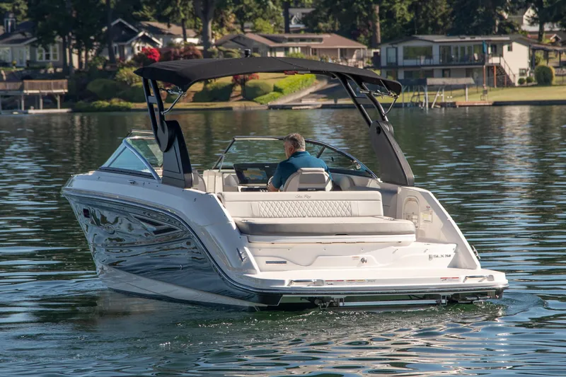 Slide: The Image of 2020 Sea Ray SLX 250 boat cruising on a serene lake. - 6
