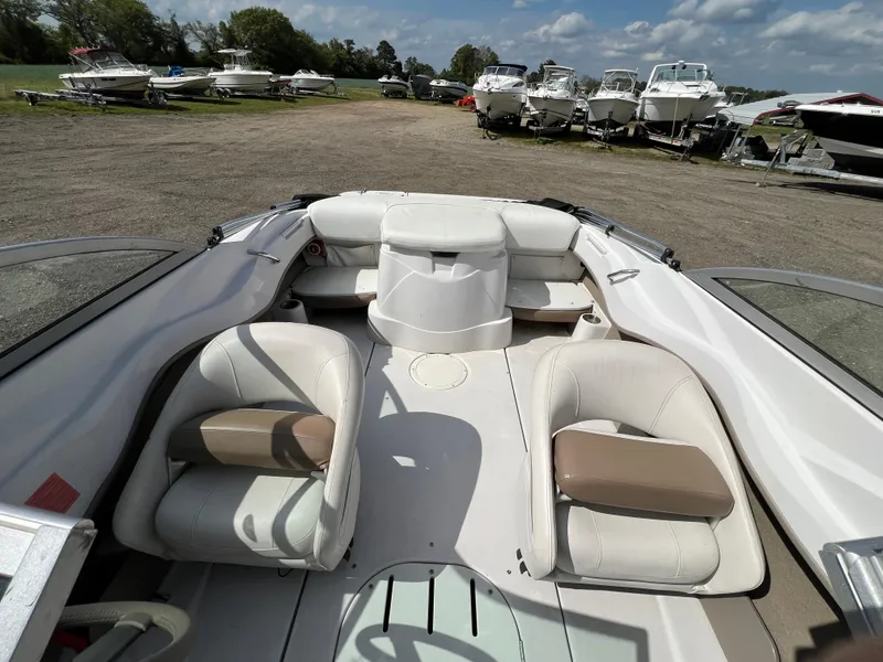 Slide: The Image of 2008 Four Winns H180 boat interior with white seating and open bow design. - 10