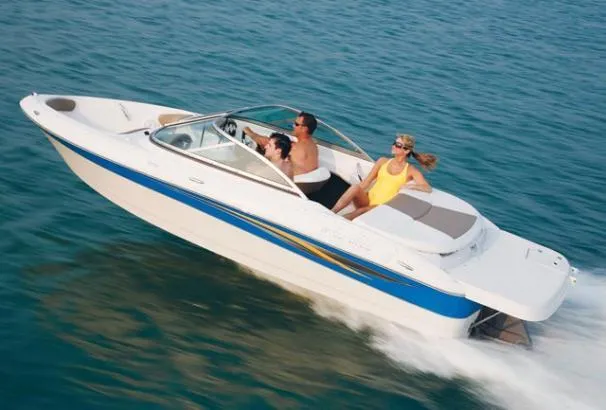 Slide: The Image of 2008 Four Winns H180 boat cruising on clear blue water with passengers enjoying the ride. - 14