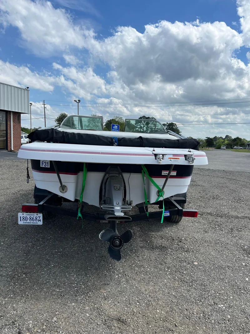 Slide: The Image of 2008 Four Winns H180 boat on trailer, parked outdoors under a cloudy sky. - 3
