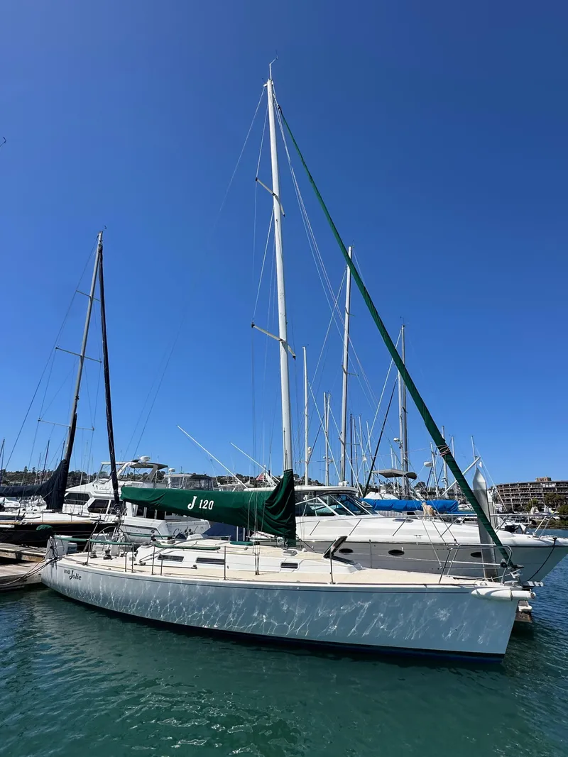 Slide: The Image of 1996 J Boats J/120 sailboat docked in marina under clear blue sky. - 0