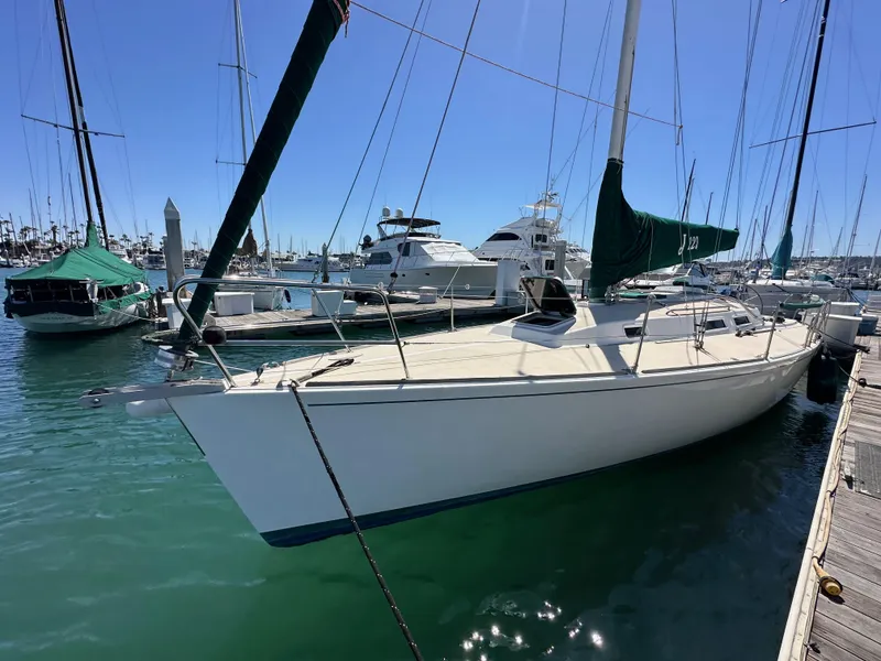 Slide: The Image of 1996 J Boats J/120 sailboat docked in marina under clear blue sky. - 10