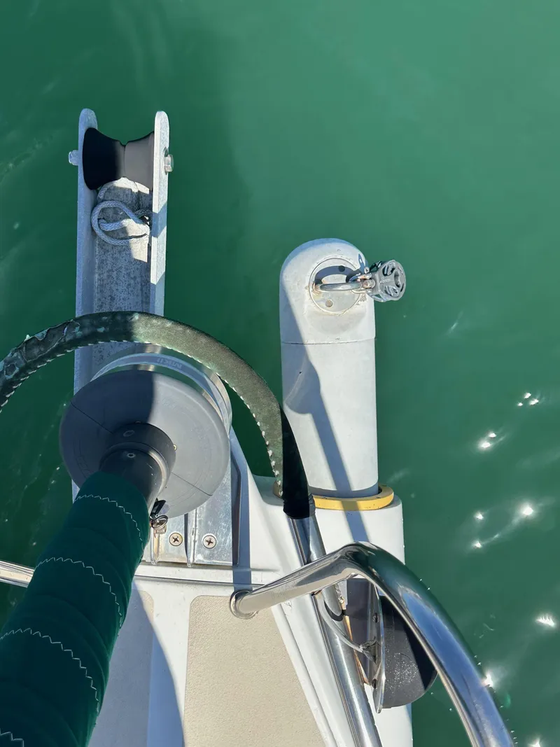 Slide: The Image of Deck view of a 1996 J Boats J/120 sailboat on calm green water. - 17