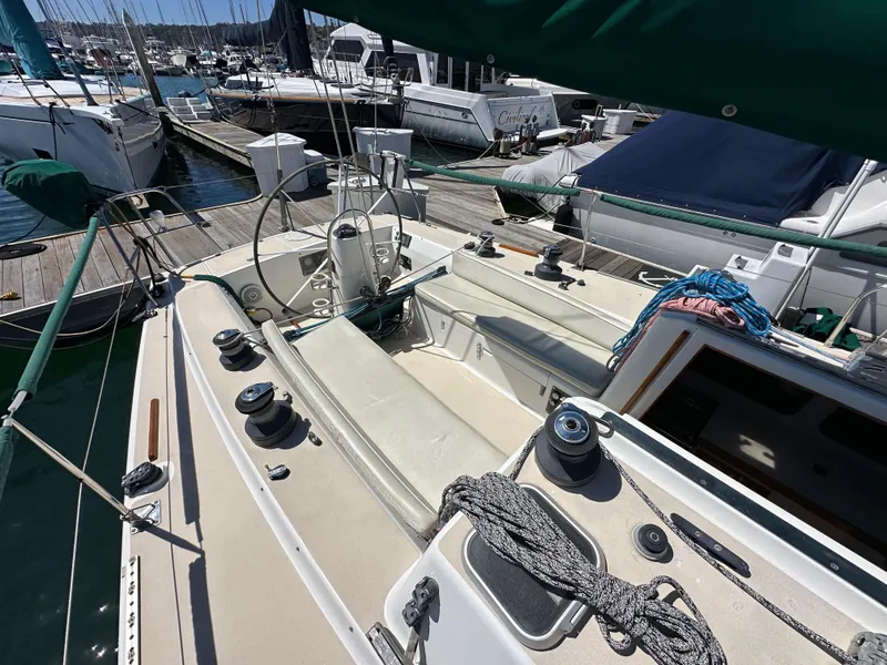 Slide: The Image of 1996 J Boats J/120 sailboat cockpit with winches and ropes, docked at marina. - 23